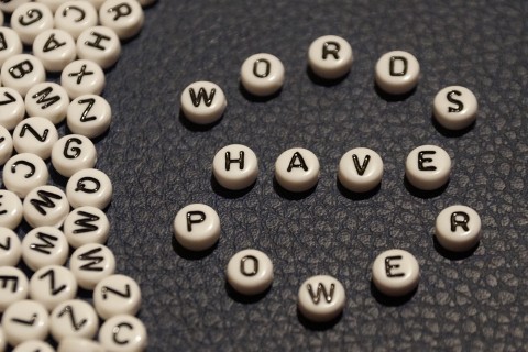 Several beads with letters on them, with beads in center spelling out "Words have power".