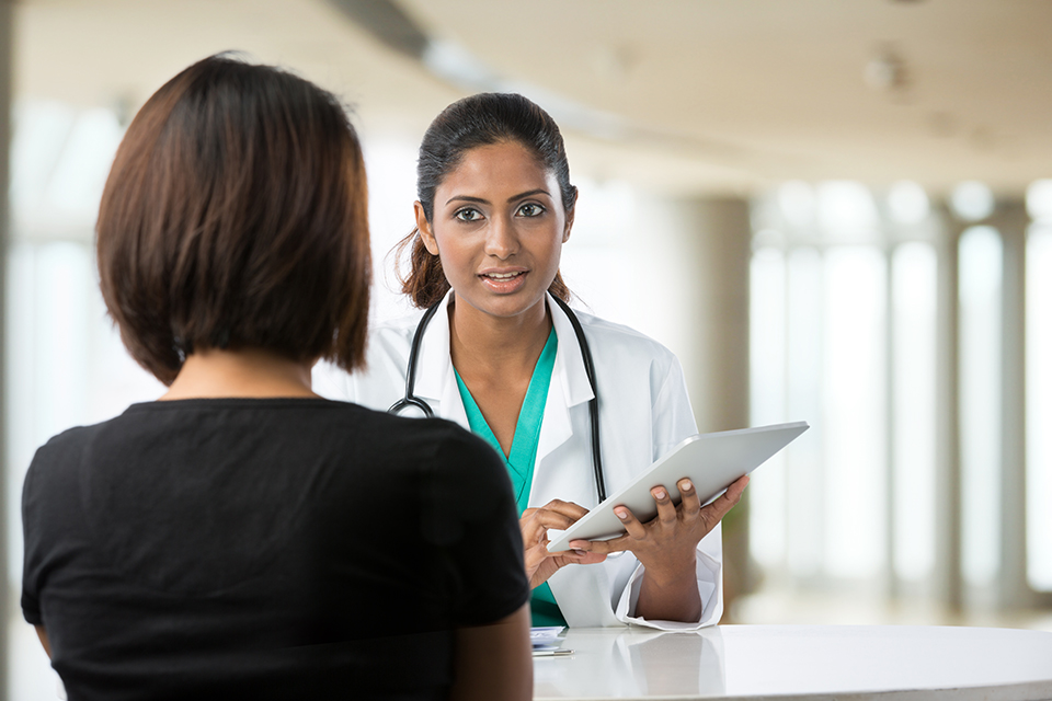 Medical professional talking to a woman. 