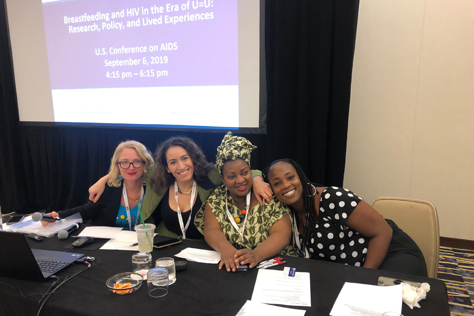 Krista Martel; Marielle Gross, MD; Claire Gasamagera; & Ciarra Covin seated at table at conference.