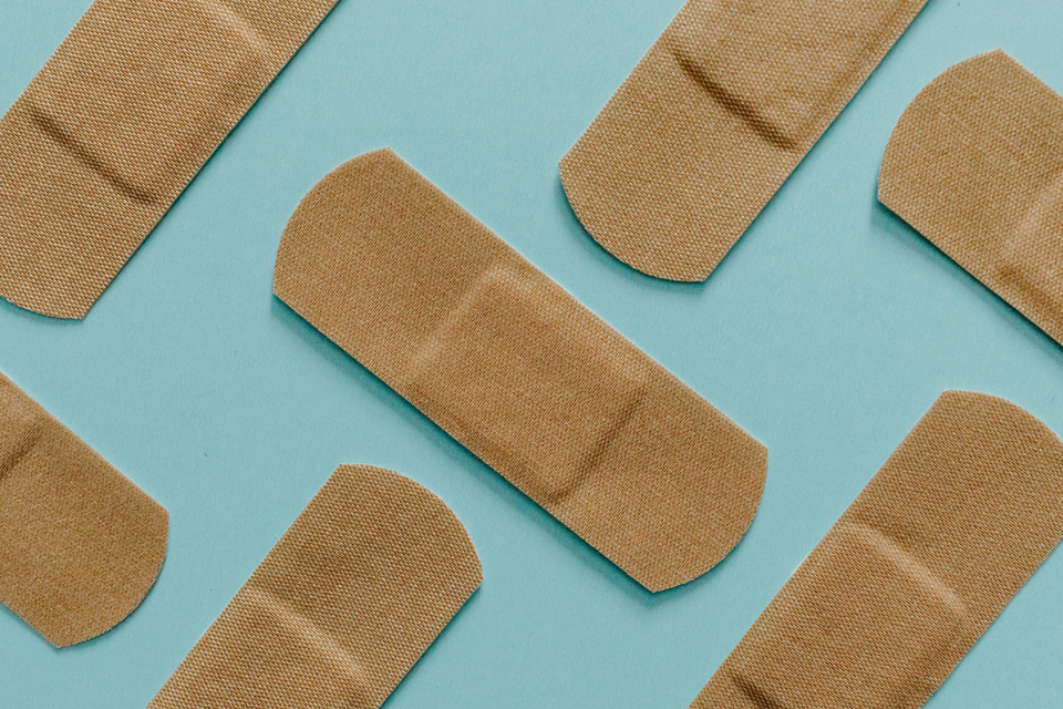 Several band-aids on a blue background.