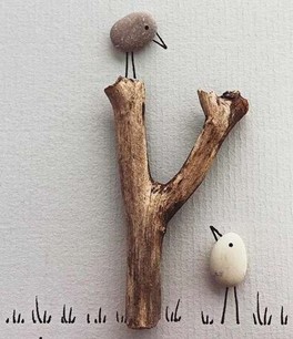 Craft project using a stick as a tree and two stones as birds.