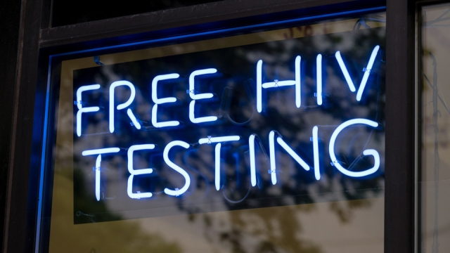 A blue neon sign that reads "Free HIV testing".