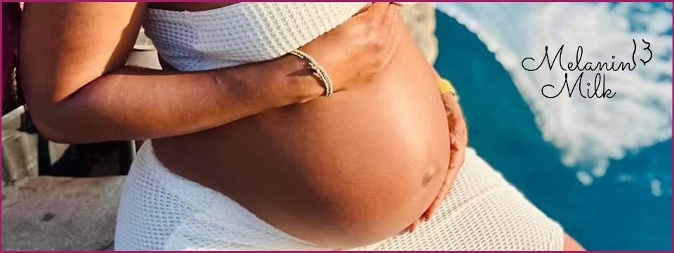 A pregnant woman next to water.